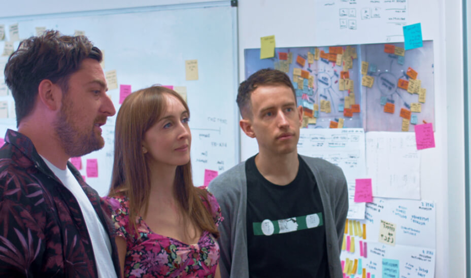Three people discussing a user journey.