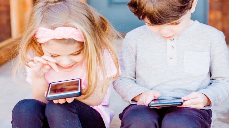 children looking at tablets