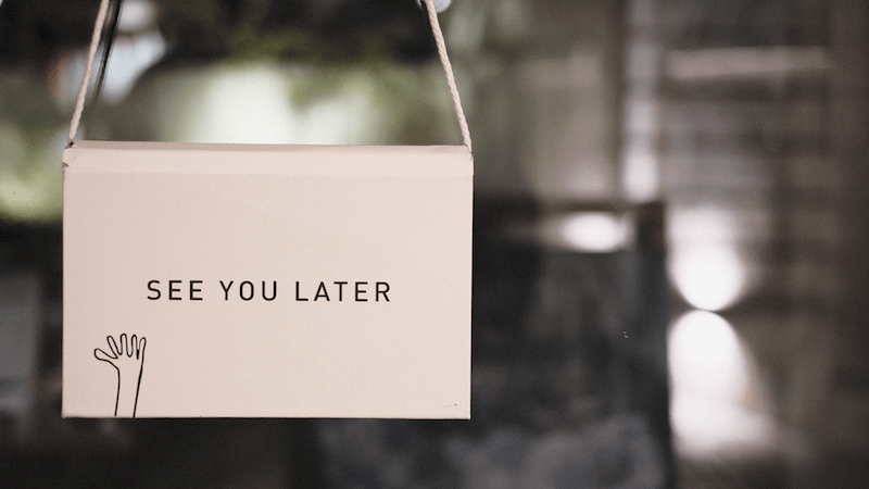 A sign saying 'See you later' with a cartoon hand waving