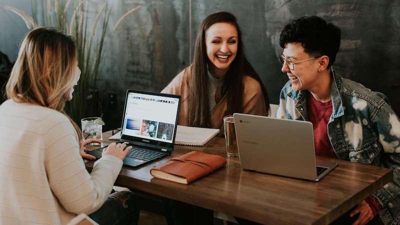 Three people working at laptops